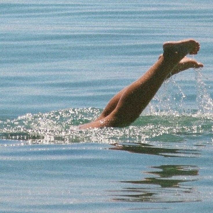 Legs diving into sparkling water